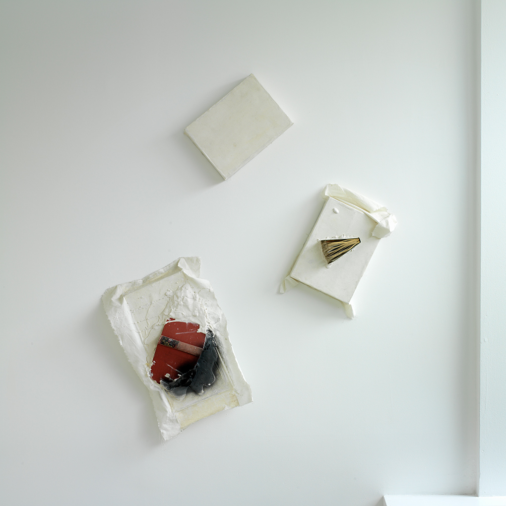 Book Relief Triad (2003/1959) Ink, plaster, books and white duck on wooden boxes. Photo: Ken Adlard (FLAT TIME: 6)